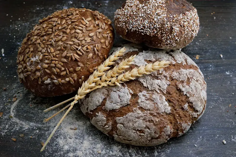 Freshly baked rustic loaves with wheat and flour